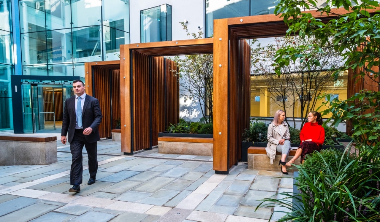 Courtyard with seating and wooden arches.