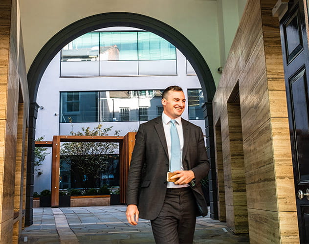 Office worker walking through courtyard.